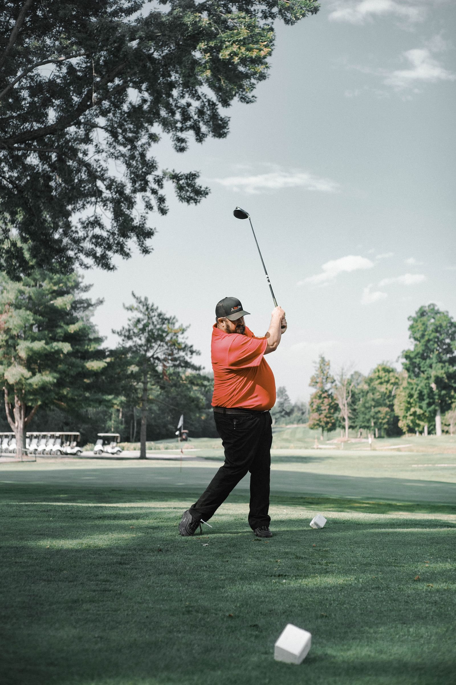 Golfer mid-backswing after setting up with an upright spine angle