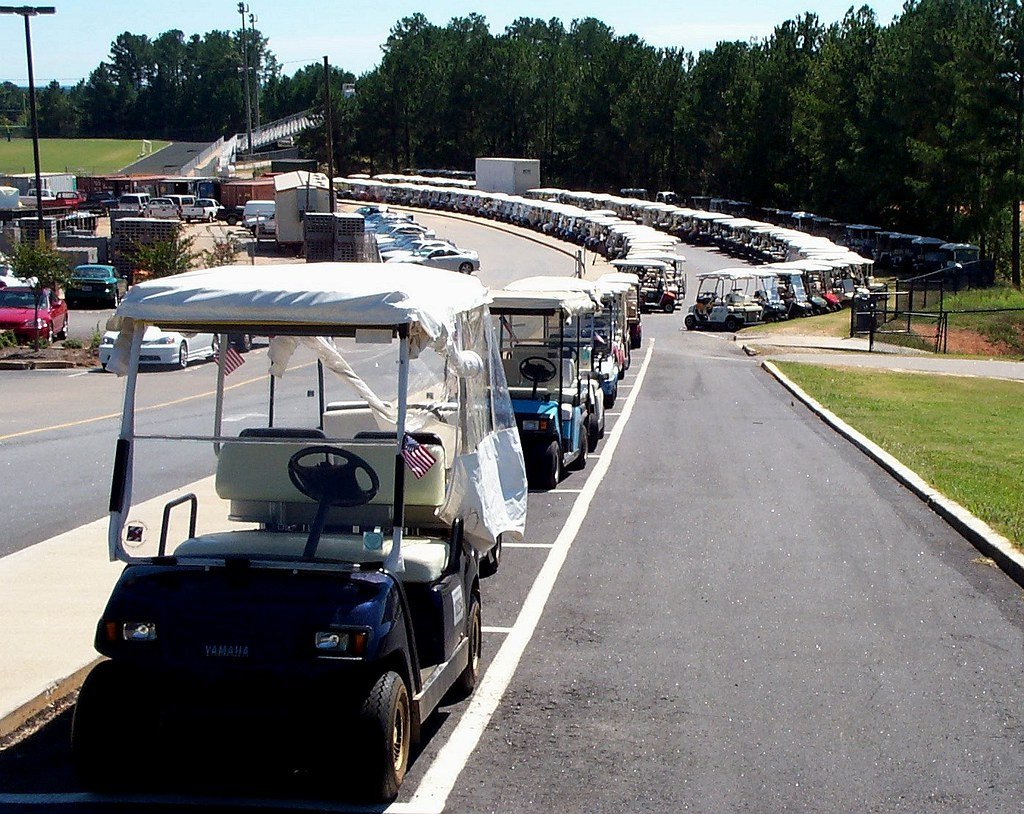 Row of parked golf carts illustrating different cart models and sizes
