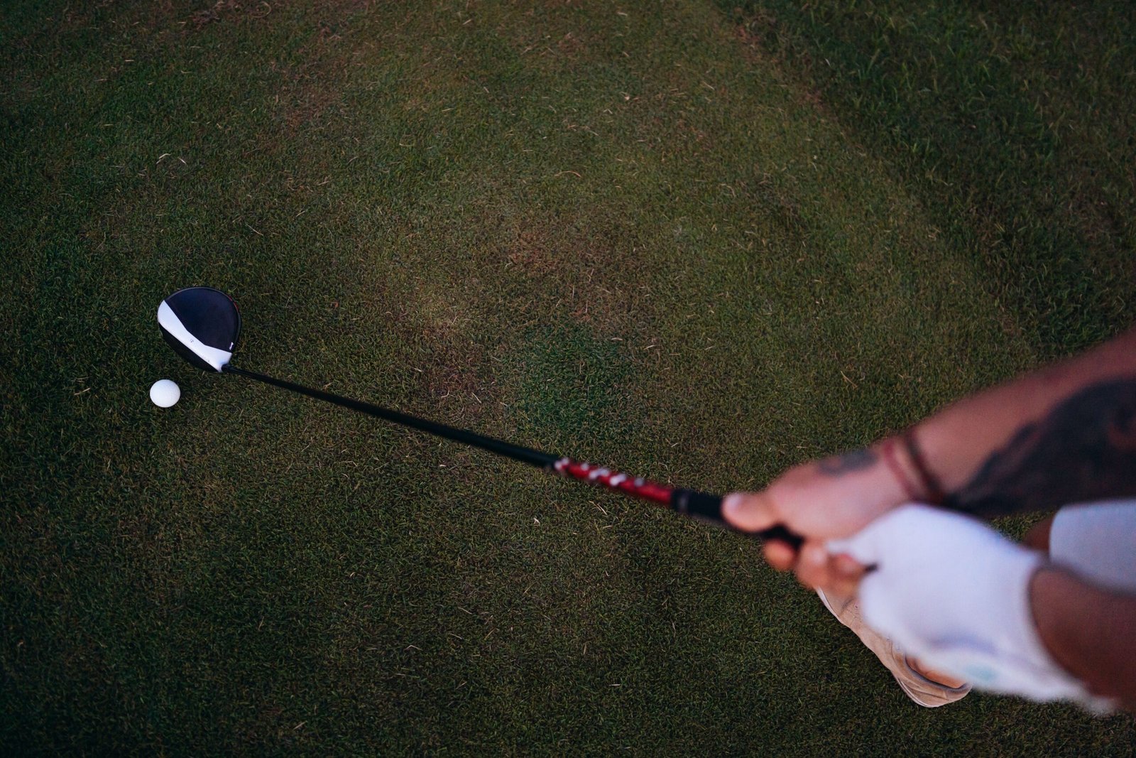 Golfer setting up before a half swing shot