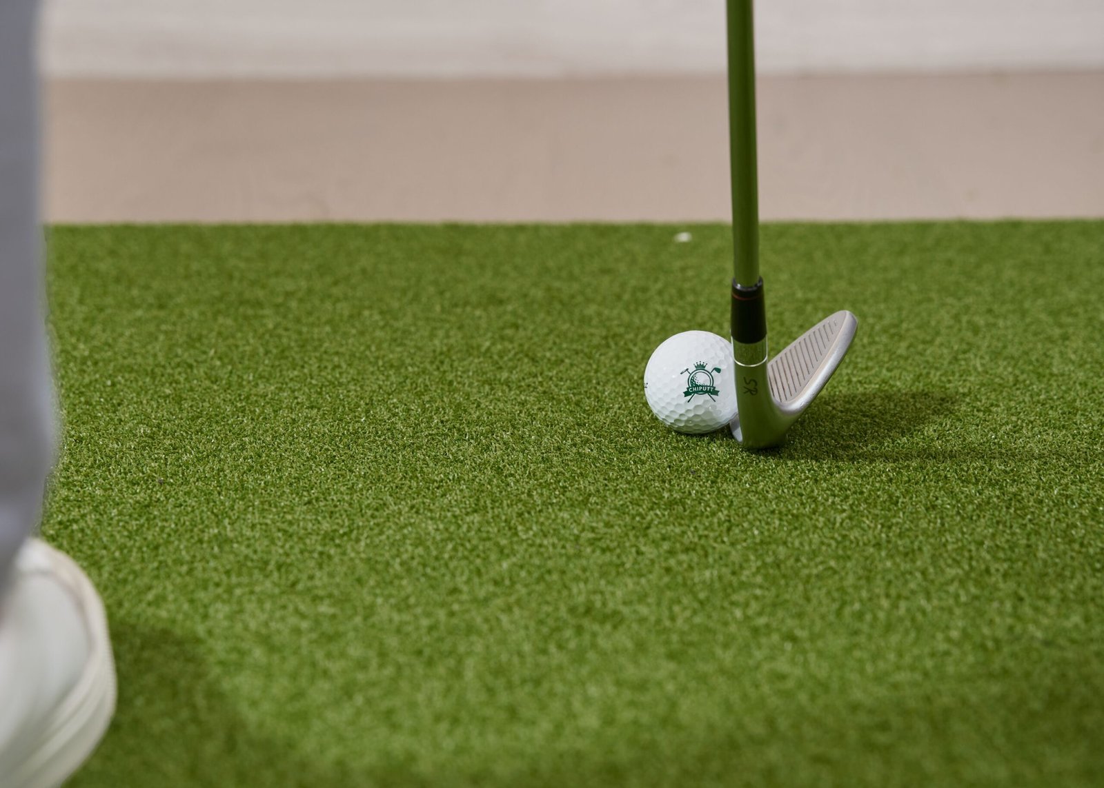 Close-up of a wedge and golf ball used for golf half swing distance control