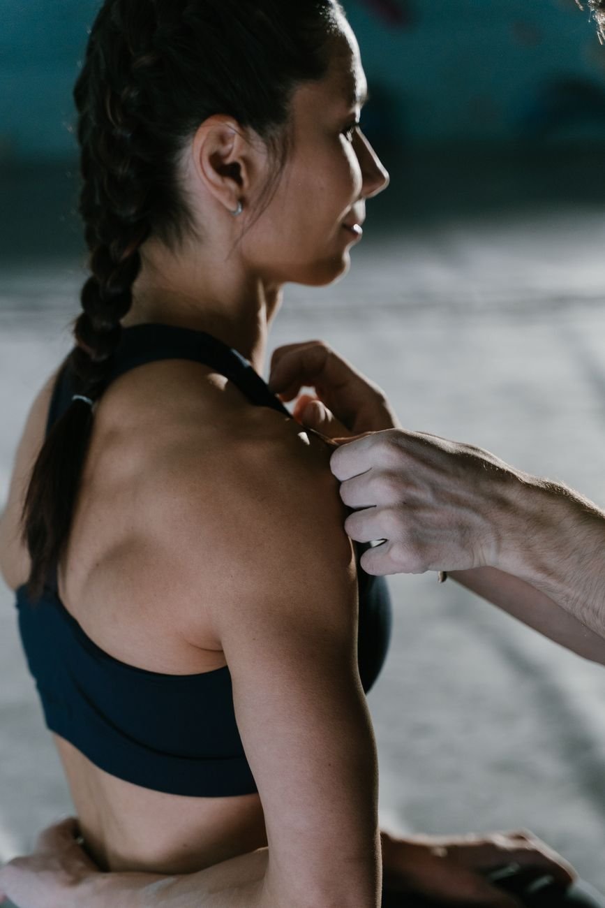 Close-up of shoulder support taping, similar to how a compression-based golf shoulder brace stabilizes the joint