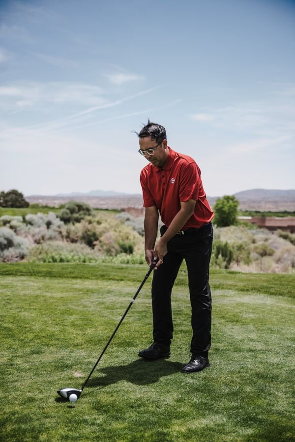 Golfer set up in address position on the course, the same position used for the train tracks alignment stick drill