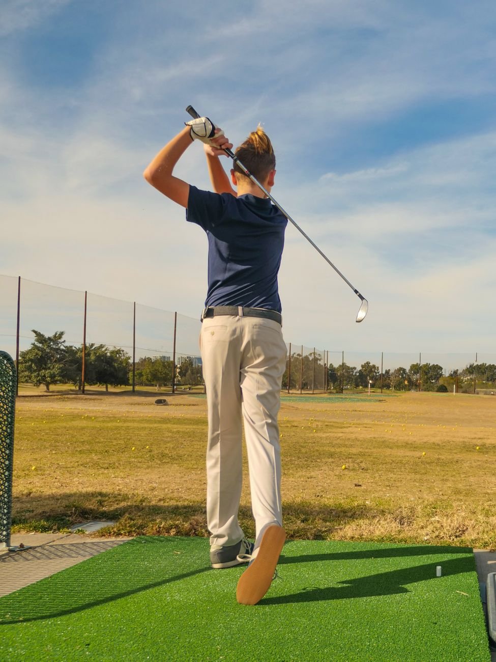 Golfer practicing swing drills at the driving range