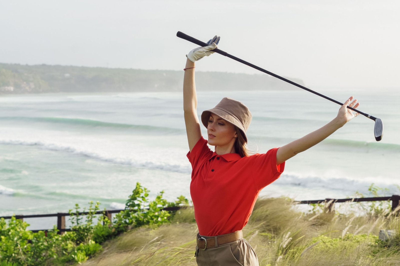 Golfer stretching with a club to improve hip mobility and protect against a reverse C golf swing