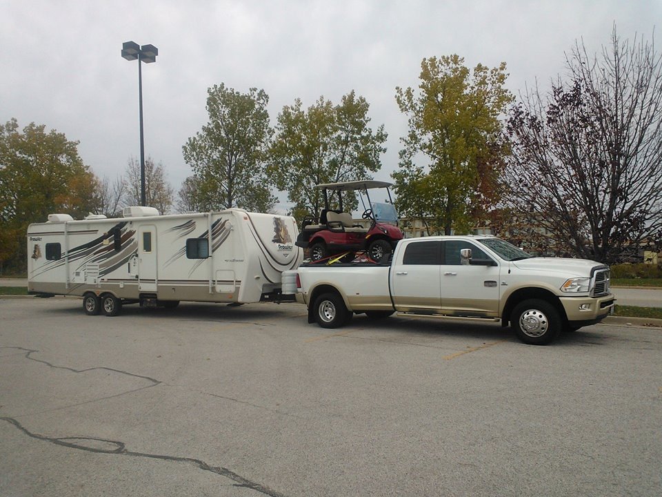 Hitch-mounted carrier showing how a trailer coupler and tongue weight attach to a tow vehicle