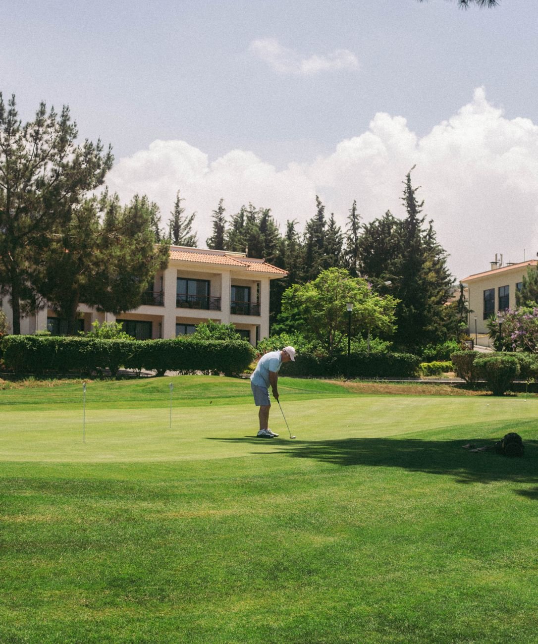 Elderly golfer focused on a putt, the kind of low-strain practice cleared early in hernia recovery