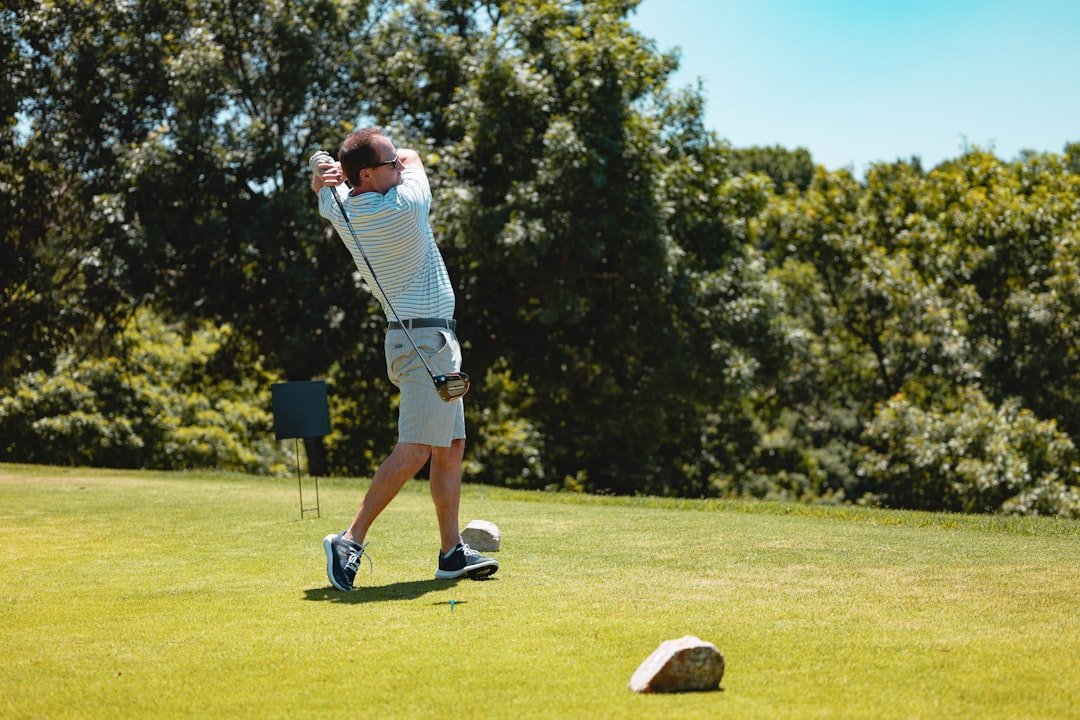 Golfer practicing iron shots at the driving range to check launch and trajectory