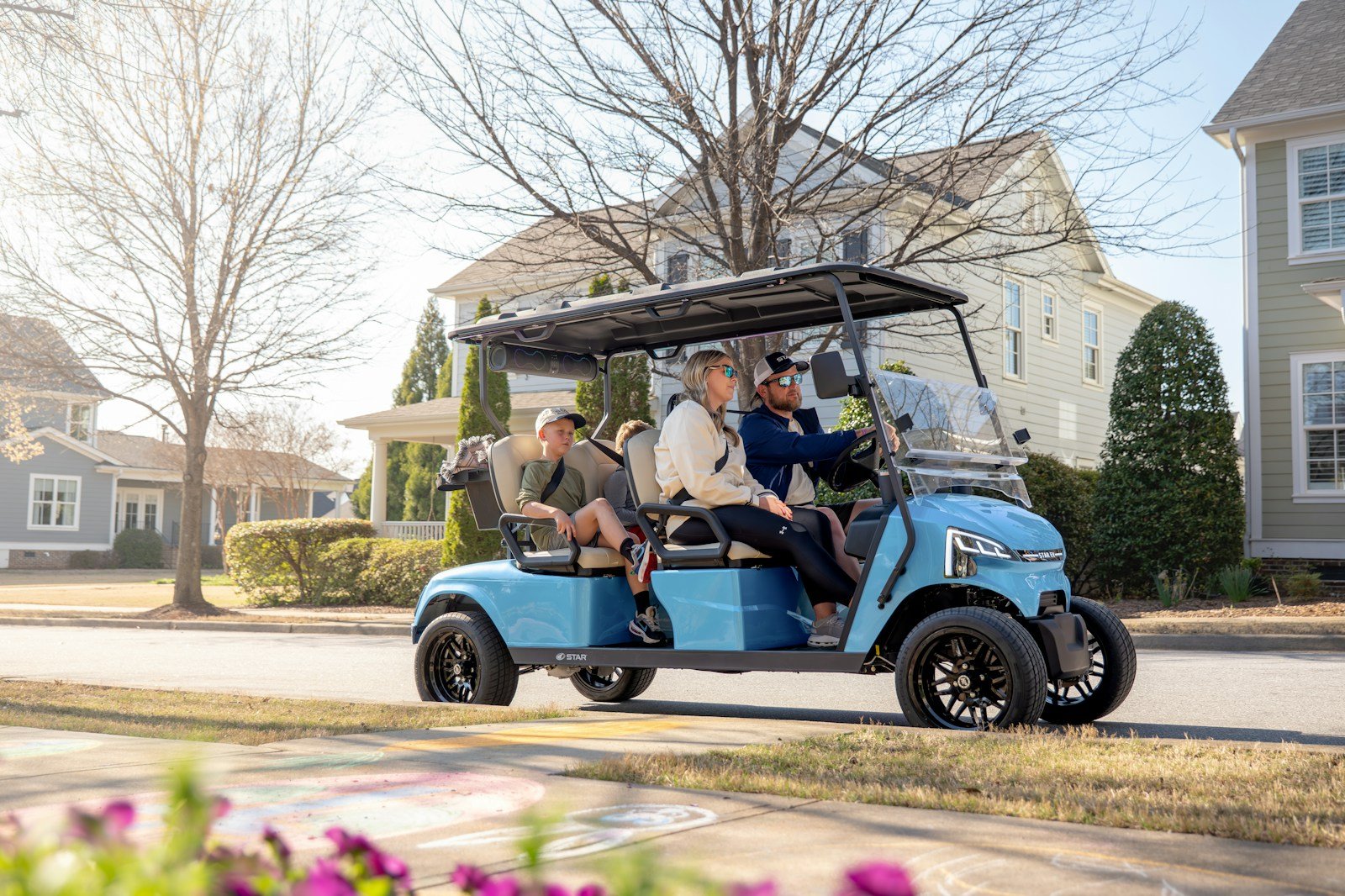 Close-up of a golf cart's front end showing the headlights and body style needed to make a golf cart street legal