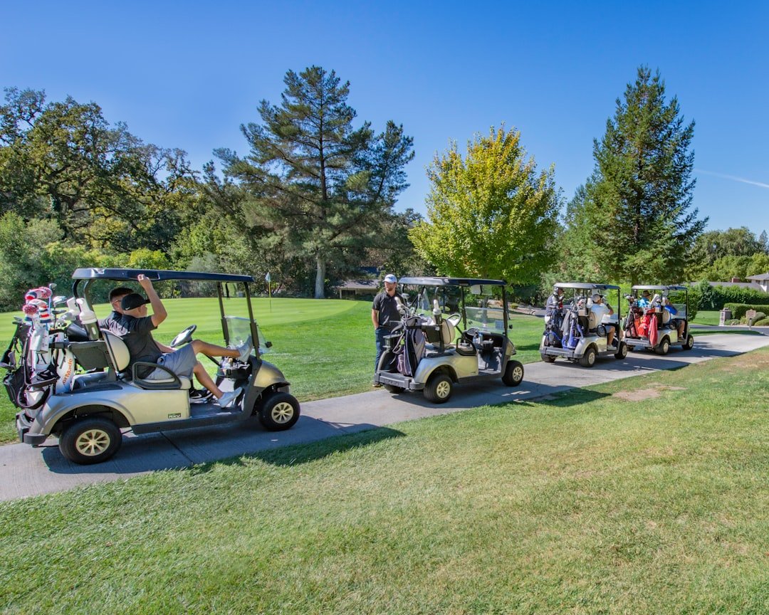 Golf carts parked on the course, each running on an electric motor and battery pack