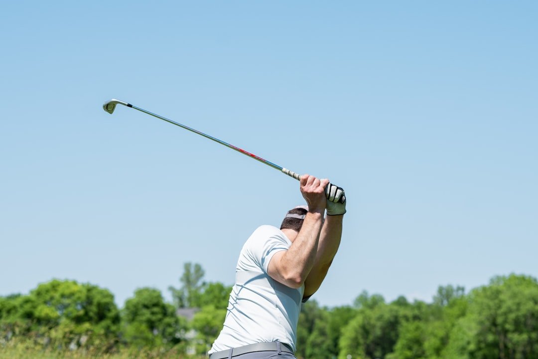 Golfer settling into the P1 golf swing position at address before starting the backswing
