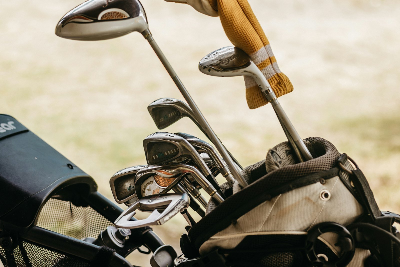A full set of golf clubs including irons and woods arranged in a golf bag