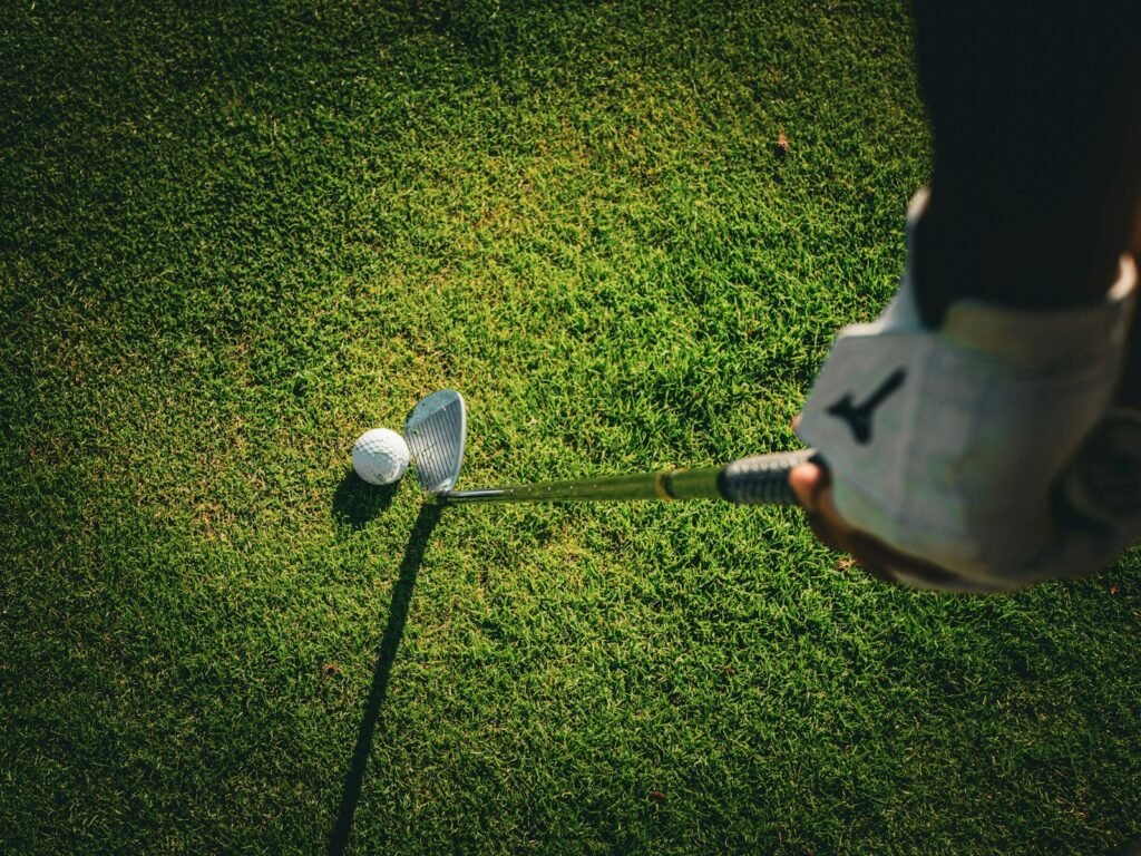 Golfer at the top of the backswing, where grip pressure and feel matter most