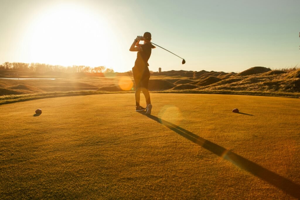 beginner golfer teeing off with a driver, the kind of forgiving swing a game-improvement set is built for