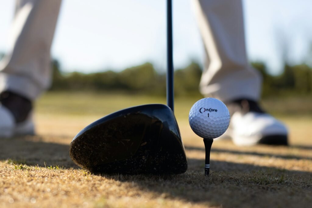 golf ball resting against a forgiving cavity-back iron clubhead from a top flite xl golf clubs set