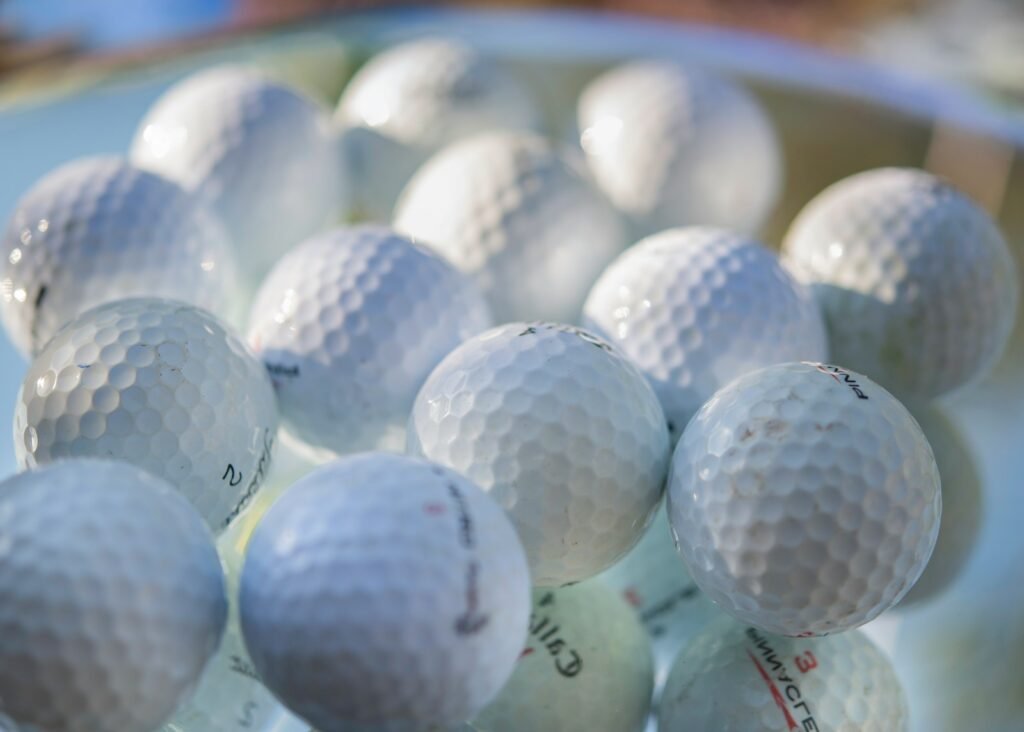 How are golf balls made? It starts with a rubber core wrapped in a dimpled cover like these.