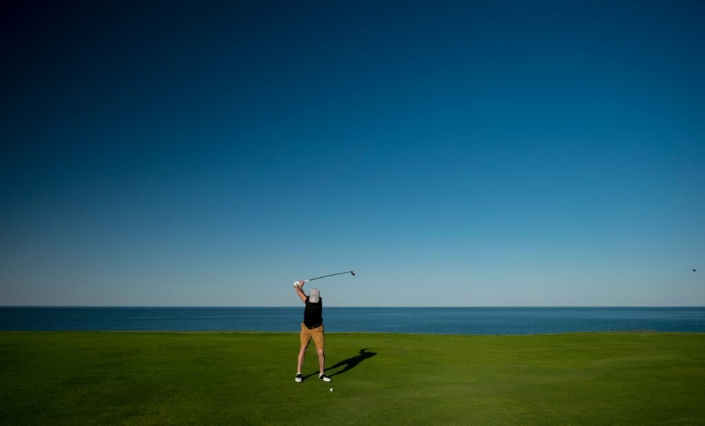 golfer following through on a fairway wood shot on the course
