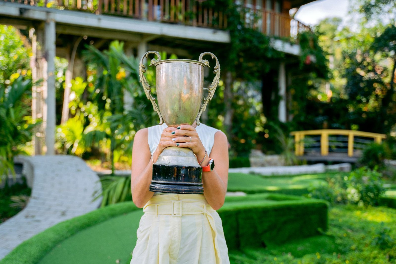 Golfer celebrating a low net golf tournament win with the trophy