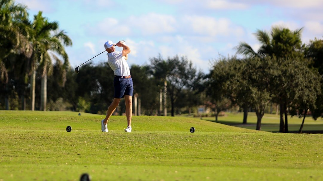 Golfer making contact with the ball during a swing on the course