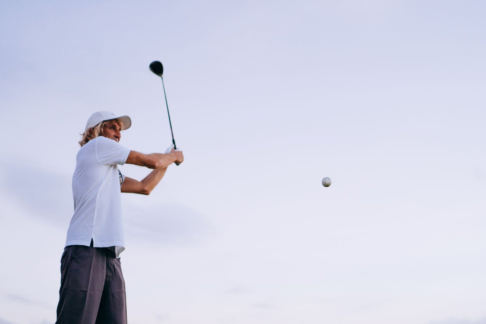Golfer through impact with weight shifted onto the lead leg