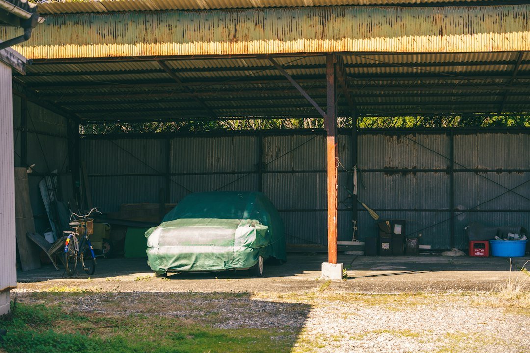 A vehicle under a fitted cover inside a dry shed, showing how to store golf cart for winter