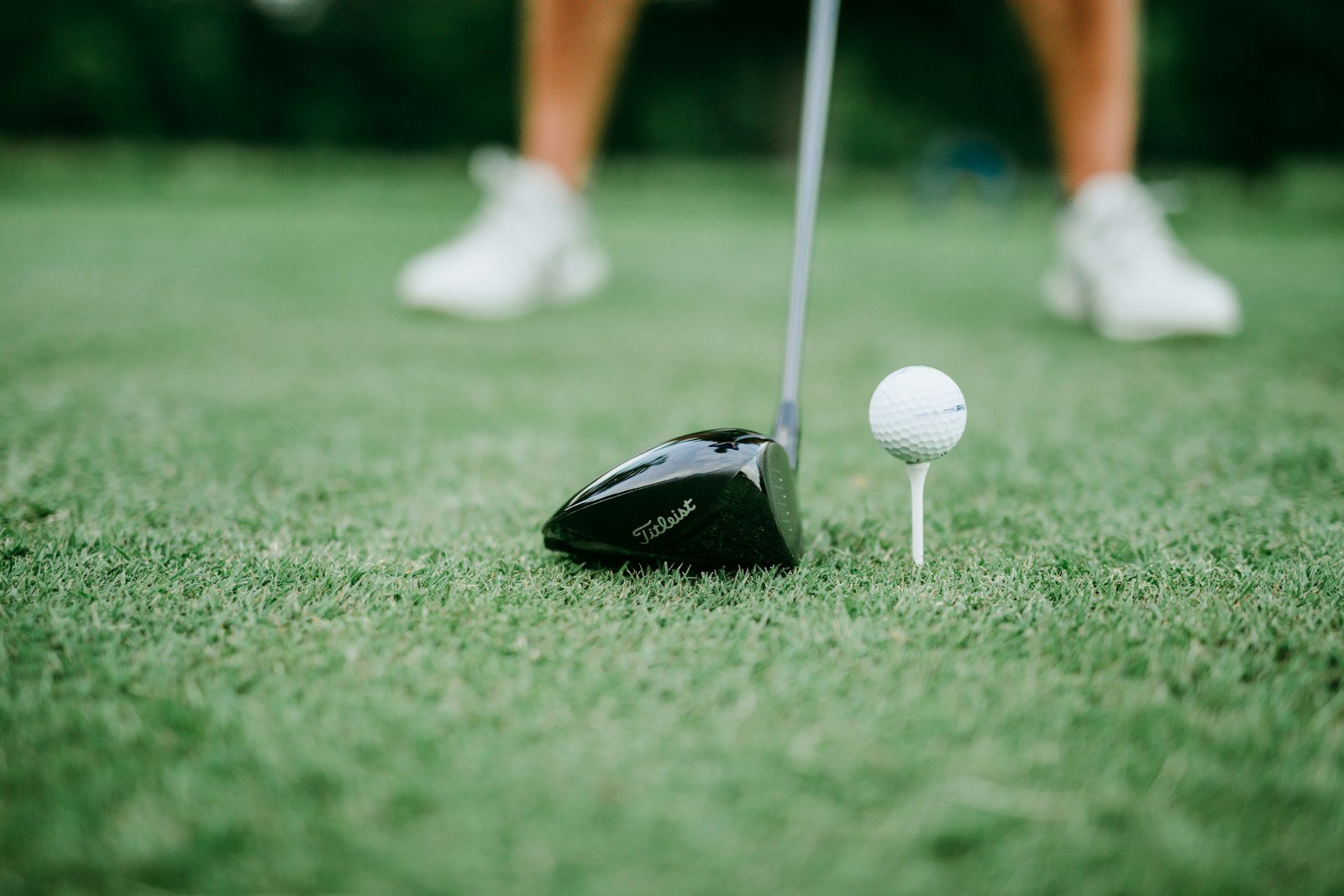 A golf club and ball on short grass, illustrating the small margin for error with a low-lofted club