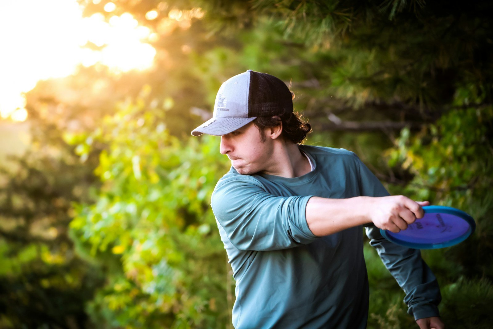 Golfer winding up with hips loaded before a forehand disc golf throw