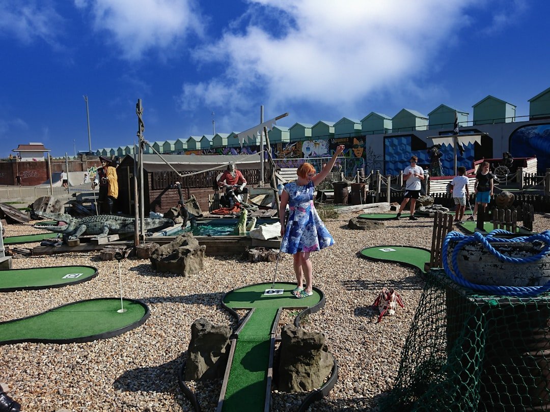 Golfer navigating an obstacle-heavy themed mini golf course