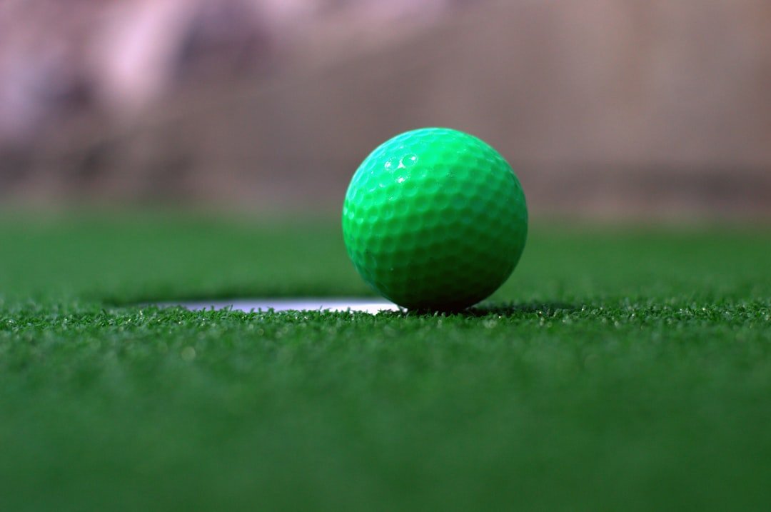 How long does mini golf take per hole - close-up of a ball resting at the edge of the hole