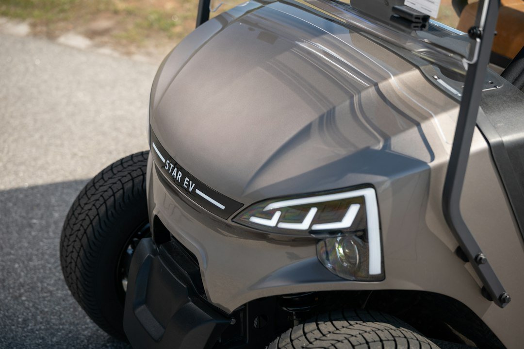 Close-up of a golf cart's LED headlight on the front cowl
