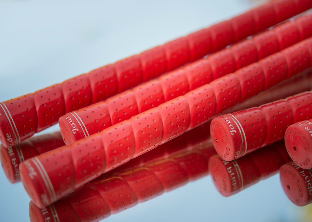 Red golf club grips waiting to be installed with golf grip solvent alternatives