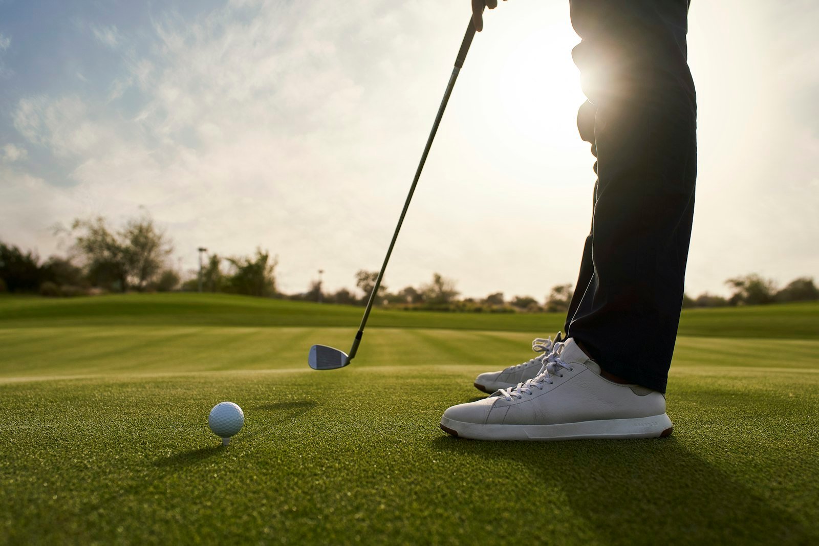 Golfer lining up a tee shot aiming for a good score for 9 holes