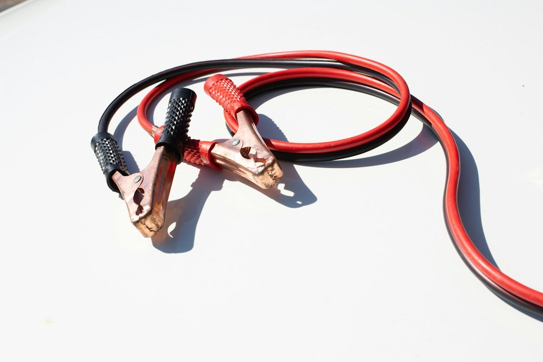 Red and black jumper cables, the kind people grab when they ask can you jump a golf cart with a car