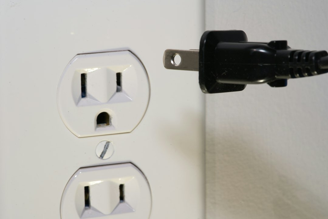 Close-up of a power plug in a wall outlet