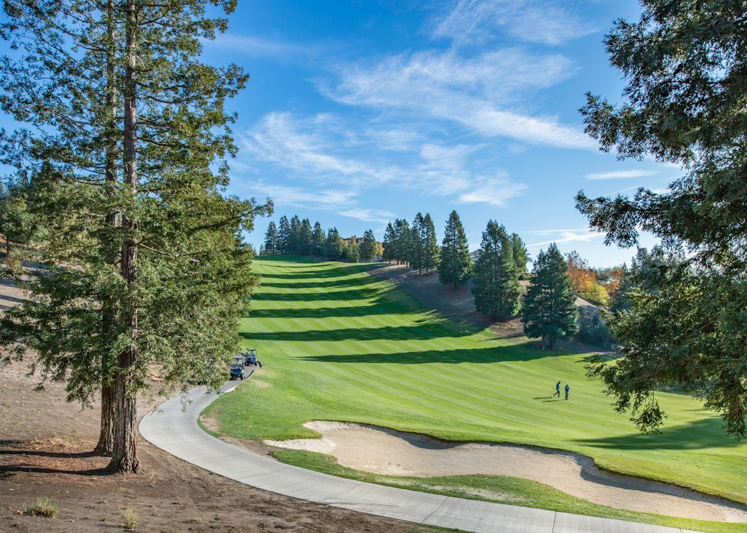 A rolling golf course with a bunker and sloping fairway, the kind of grade that exposes a weak cart